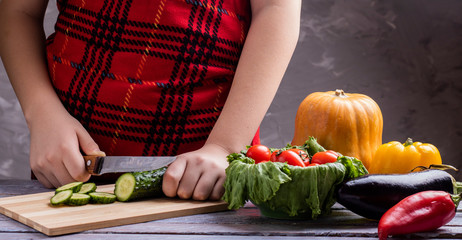 kid cooks vegetables for vegan meal