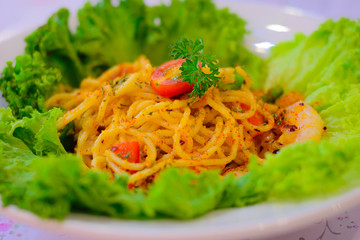 Spaghetti Aglio Olio with shrimps in a bed of lettuce