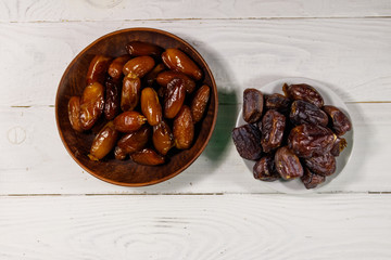 Dried dates fruit on white wooden table. Top view