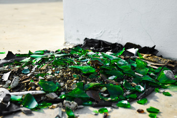 Broken green glass crack spread pile on the floor.