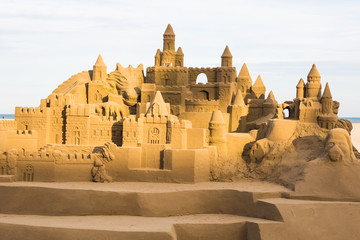 Fototapeta na wymiar Fantasy city made from sand against a blue sky