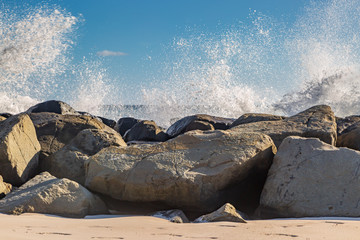 Waves crashing over rocks on a beach, on the island of Barbados