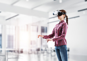 Girl in virtual reality mask experiencing virtual technology wor