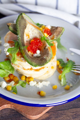 pancakes with avocado and caviar top view.
