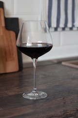 a glass of red wine on the table.