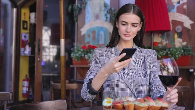 Beautiful Woman Taking Food Photos On Mobile Phone At Restaurant