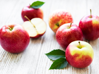 Fresh red apples on a old wooden table
