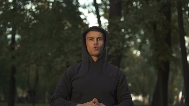 Man doing breathing exercises at central park, personal weightloss training