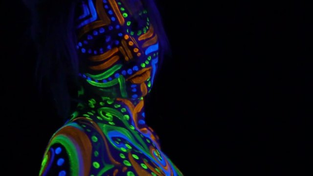 Beautiful young lady with glowing body art, close up