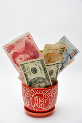 Vase with overflowing Paper Currency.