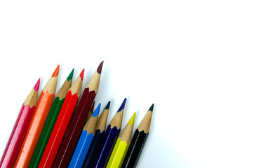 Multi colored pencils on white background