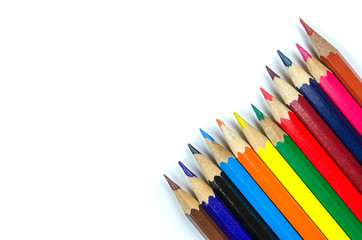 Multi colored pencils on white background
