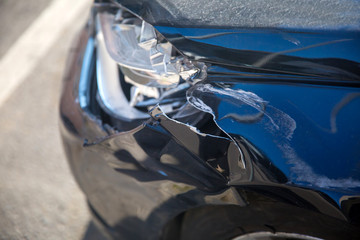 Car crash or accident. Front fender and light damage and scratches on bumper. Broken vehicle