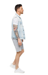 Fototapeta premium Back view of going handsome man in a shorts. walking young guy .