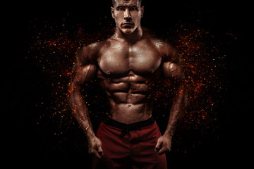 Fototapeta na wymiar Brutal strong muscular bodybuilder athlete man pumping up muscles on black background. Workout bodybuilding concept. Copy space for sport nutrition ads.