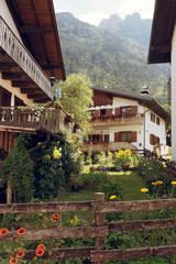 Caralte di Cadore, Italy - August 12, 2018: Beautiful old and modern buildings in a mountain village.