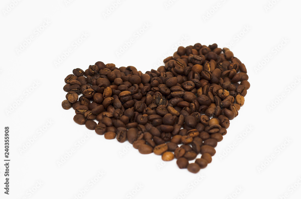 Wall mural roasted coffee beans lie on a white background in the form of a heart