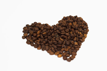 roasted coffee beans lie on a white background in the form of a heart