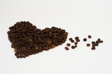 roasted coffee beans lie on a white background in the form of a heart