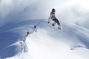 Naklejka na ściany i meble Skiers climbing a snowy mountain