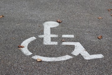 The handicap icon painted white on the road surface.