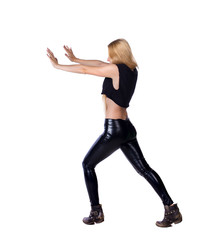 Fototapeta premium back view of woman pushes wall