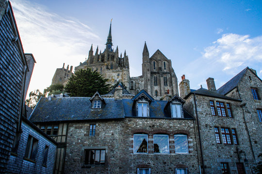 Stone medieval houses and a cathedral in the city of Seint Michel Abbey in French Normandy
