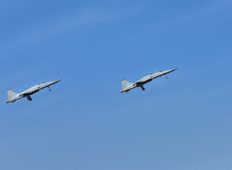 Fighter jet military aircraft flying with high speed take off  from runway on blue sky 