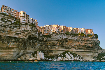 View of old houses of Bonifacio up on the cliff above the sea in Corsica during sunny summer day