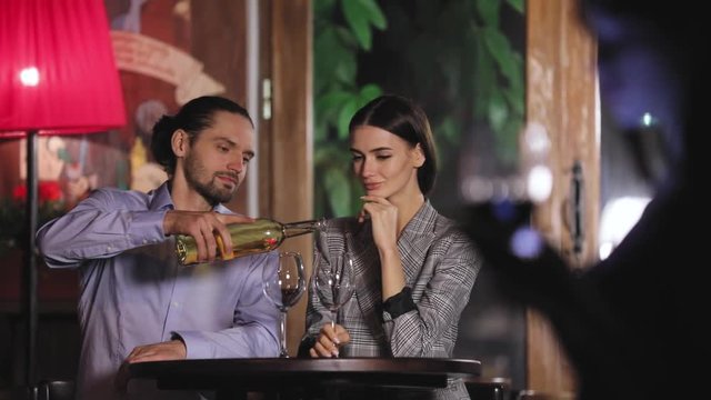 Beautiful Couple On Romantic Date Drinking Wine At Restaurant
