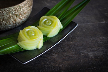 Thai desserts layer sweets cake putting on the  Pandanus amaryllifolius come leaf and black plate...