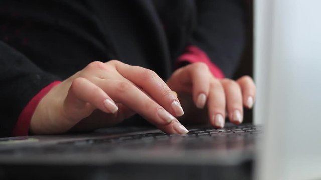 Women's hands work with a laptop