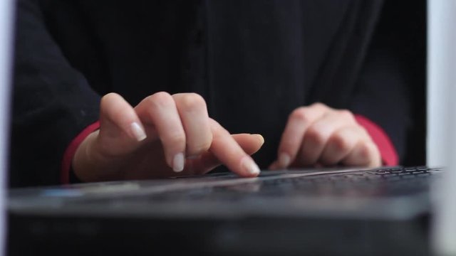 Women's hands work with a laptop