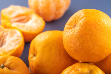 Beautiful and delicous tangerine isolated on airy blue background with bamboo sieve, new modern concept of chinese new year, close up, copy space
