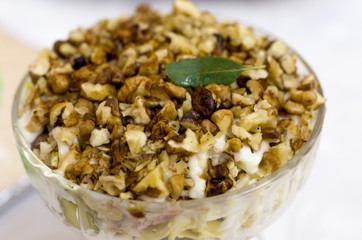A plate with walnuts. Walnut kernels. Nuts in sour cream.
