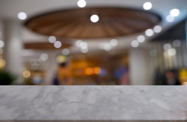 Empty white marble stone table in front of abstract blurred background of shopping mall, cafe and coffee shop interior. can be used for display or montage your products - Image.