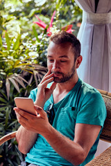 Modern man using cellphone outdoors.