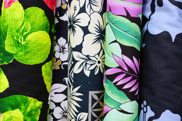 Bolts of colorful Polynesian fabrics with tropical flower motifs in Tahiti