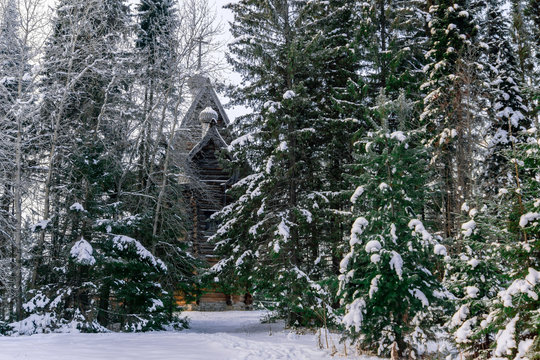 old wooden church in the winter forest