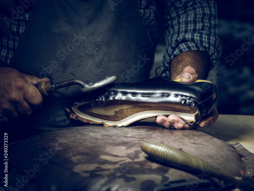 Midsection of shoemaker making shoes