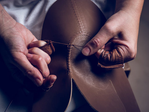 Crop hands stitching leather for shoes
