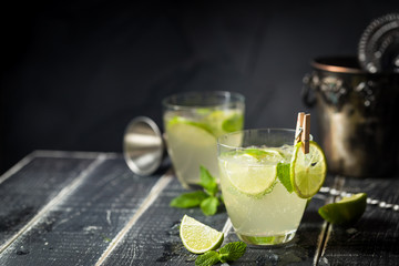 Lemonade or mojito cocktail with lemon and mint, cold refreshing drink or beverage with ice