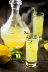 Traditional italian lemon liqueur limoncello and fresh citrus lemon. Alcoholic beverage.