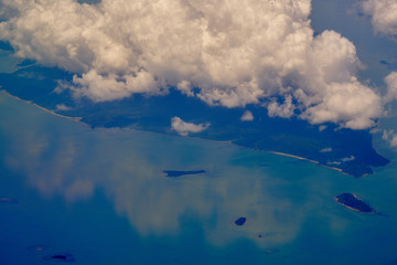 Naklejka na ściany i meble Big clouds over the tropical paradise island. View from plane. Spectacular destination point.