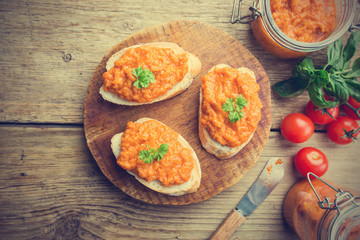 Homemade caviar of zucchini on a slice of bread in rustic style, top view