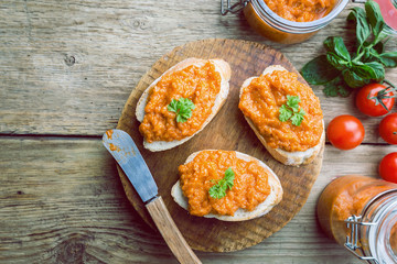 Homemade caviar of zucchini on a slice of bread in rustic style, top view
