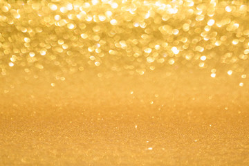 Shining gold glitter background. Abstract texture with bokeh effect.