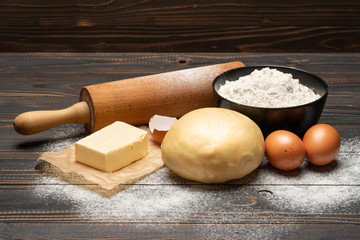unrolled and unbaked Shortcrust pastry dough recipe on wooden background