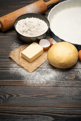 unrolled and unbaked Shortcrust pastry dough recipe on wooden background