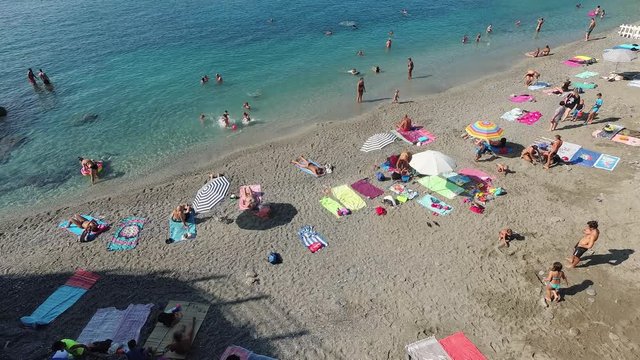 People bathing on the beach in Cinque Terre Italy